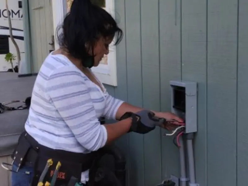 Licensed electrician wiring an exterior subpanel in Waycross